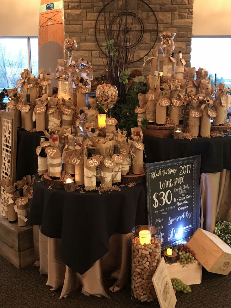 the table is set up with candles and gifts for guests to buy at the event