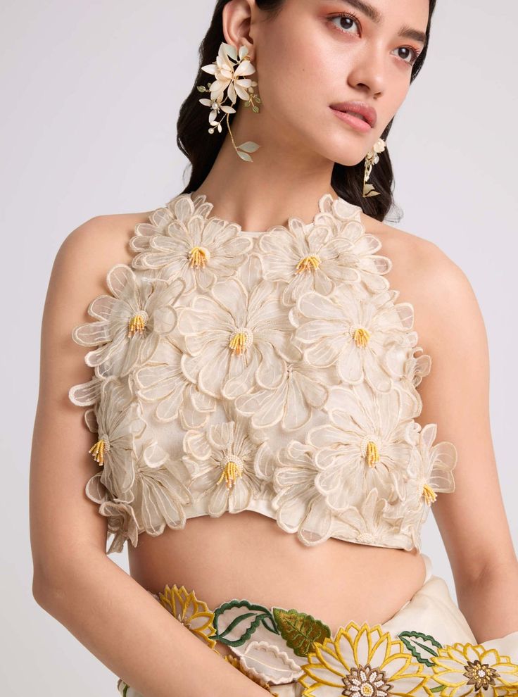 Ivory Daisy Applique Top by Chandrima available on Indiaspopup.com Silk Top With Floral Embroidery For Reception, Sleeveless Organza Tops For Spring, Elegant Sleeveless Organza Blouse, Festive Floral Embellished Summer Top, Elegant Sleeveless Organza Top, Feminine Festive Wedding Blouse, Spring Silk Tops With Resham Embroidery, Silk Blouse With Floral Embroidery For Reception, Silk Tops With Resham Embroidery For Spring