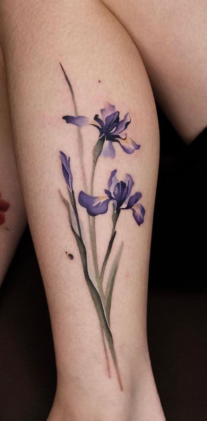 a woman's leg with purple flowers on it