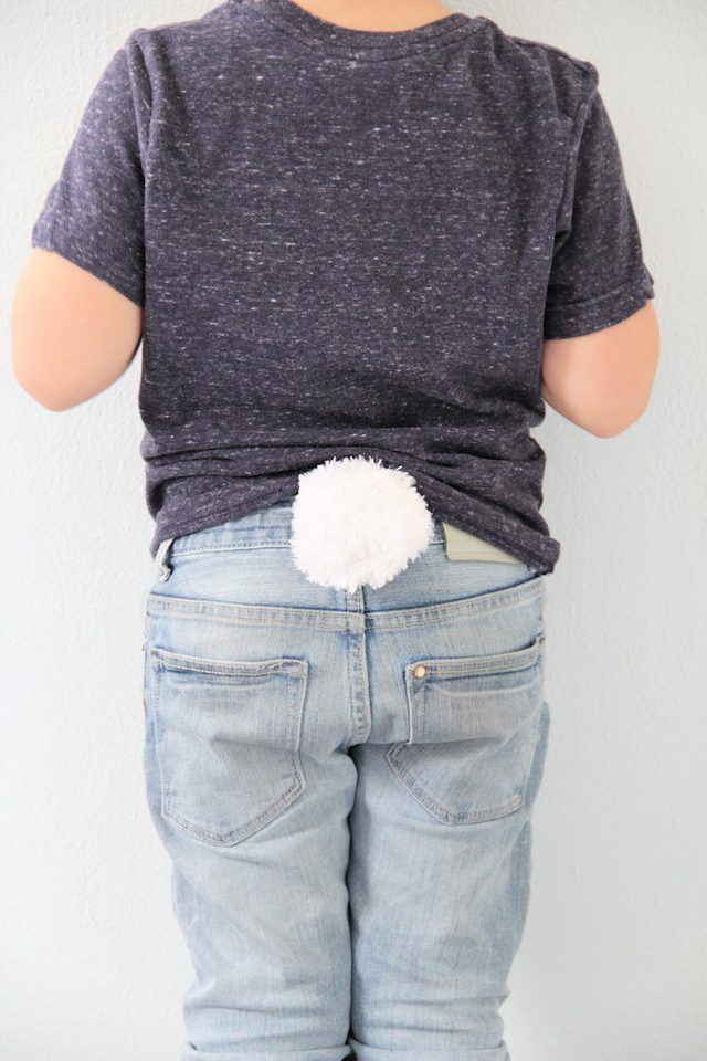 a person standing with their back to the camera wearing jeans and a t - shirt