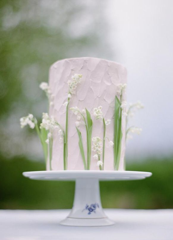 a white wedding cake with flowers on top