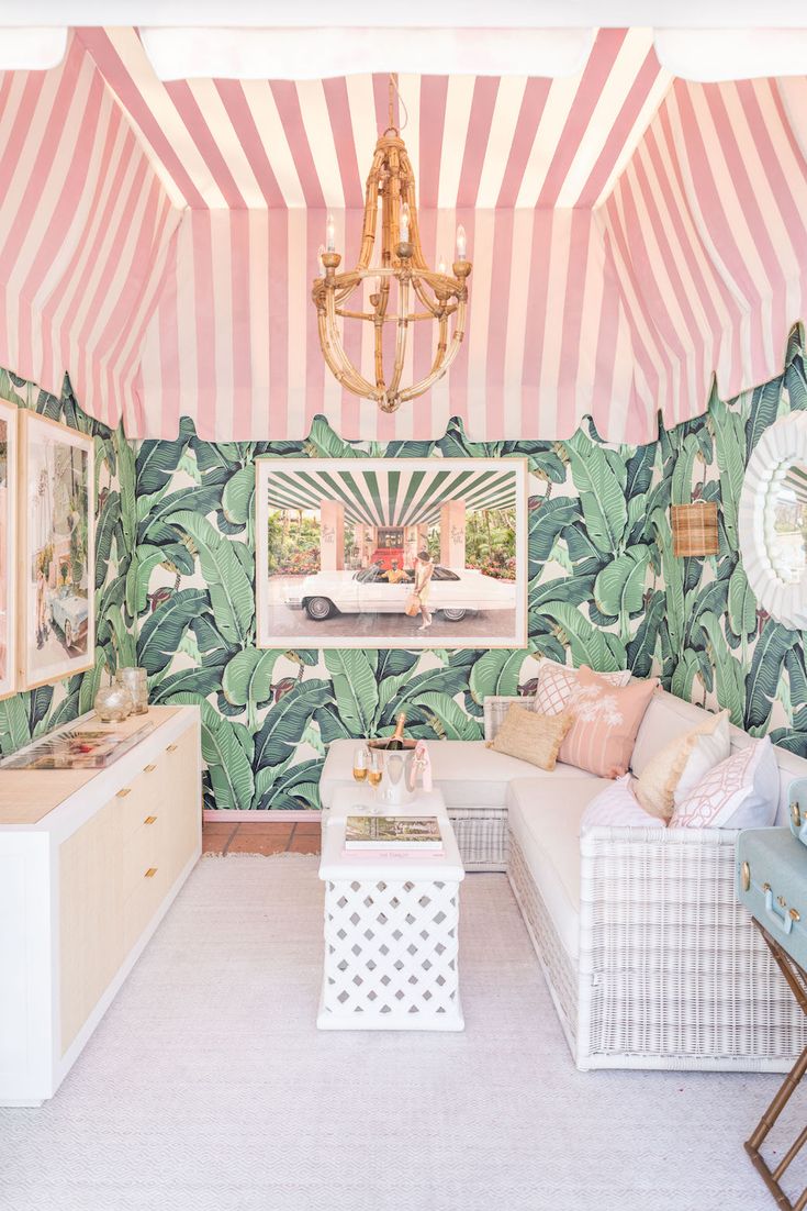 an instagram image of a living room with pink and green wallpaper on the walls