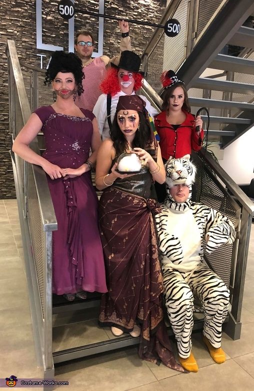 group of people dressed in costumes posing on an escalator