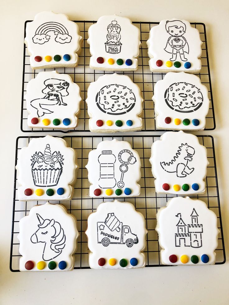 decorated cookies on a cooling rack with markers