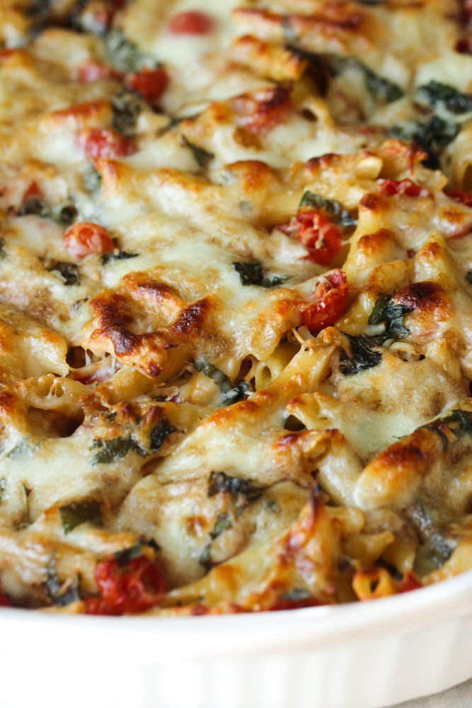 a casserole dish filled with pasta and spinach