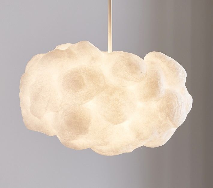 a white cloud shaped light hanging from a ceiling