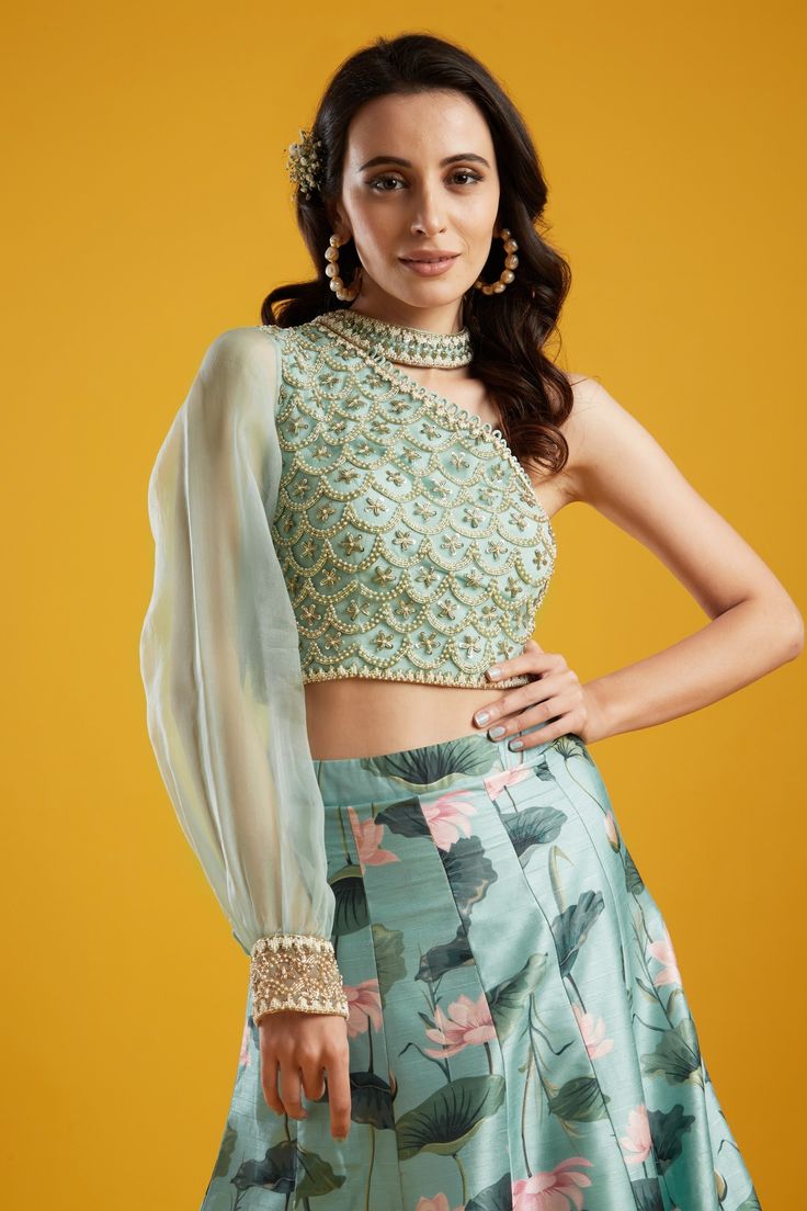 Editor's Note This set features a kali lehenga with one shoulder blouse. Color: Aqua Fabric: Net; Organza; Raw Silk Care: Dry Clean Only About the Designer Aayushi Maniar label was founded in the year 2016. The brand defines luxury with comfort and modern design philosophy. Her styles comprise fashion-forward statement pieces like Cape tops, Pre draped sarees, Lehengas and Anarkalis. The aim is to keep traditional aspects with a fresh and renewed perspective that is perfect for a modern woman, a Festive Anarkali Top With Sheer Dupatta, Traditional One-shoulder Set With Dupatta, Festive One-shoulder Set With Resham Embroidery, Traditional Festive Tops With Sheer Dupatta, Anarkali Tops With Dupatta For Wedding, One-shoulder Zari Work Designer Wear Set, Traditional One-shoulder Pre-draped Saree With Zari Work, Wedding Tops With Dupatta For Eid, Traditional One Shoulder Pre-draped Saree For Festive Occasions