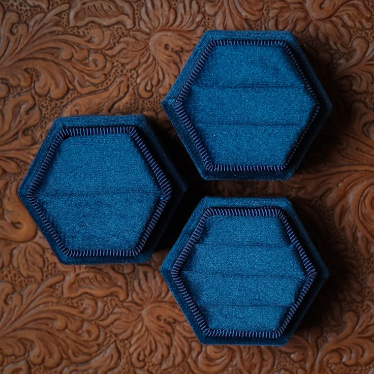 three blue hexagonals sitting on top of a wooden table