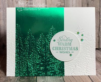 a green and white christmas card sitting on top of a wooden table