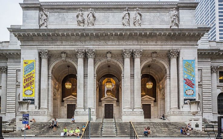 people are sitting on the steps in front of an old building with columns and arches