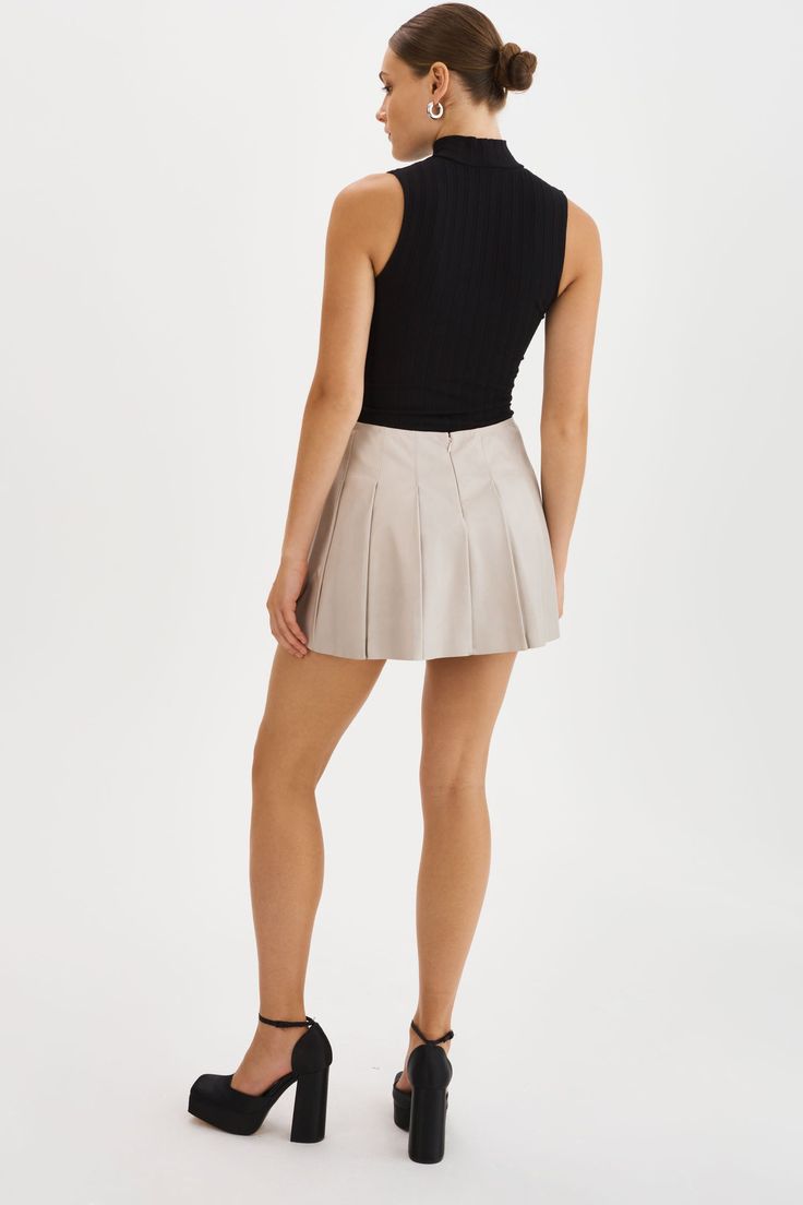 The Juliana Pleated Skirt is effortlessly feminine with its playful pleats and mini length. Pair it with sneakers and an oversized sweater for a casual look, or dress it up with knee-high boots for an evening ensemble. Chic Pleated Hem Skort For Fall, Chic Fall Pleated Skort, Chic Fall Skort With Pleated Hem, Chic Accordion Pleats Mini Skirt For Fall, Fall Pleated Hem Skirt Skort, Fall Pleated Hem Skort, Chic Short Pleated Skirt For Fall, Chic Short Pleated Fall Skirt, Chic Pleated Tennis Skirt For Fall