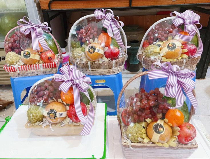 three baskets filled with different types of fruit