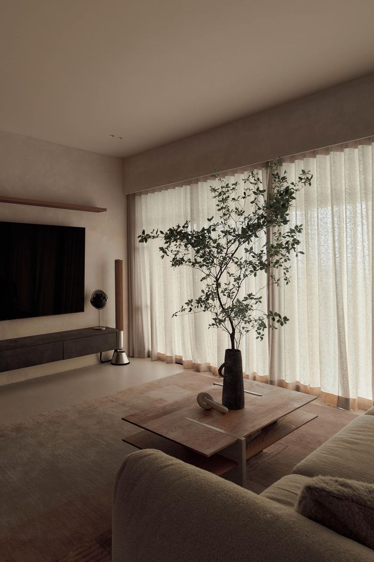 a living room filled with furniture and a flat screen tv mounted to the side of a wall