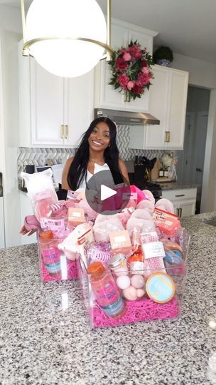 a woman standing in front of a counter filled with bath products