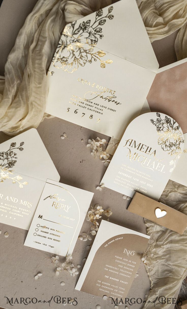 the wedding stationery is laid out on top of each other