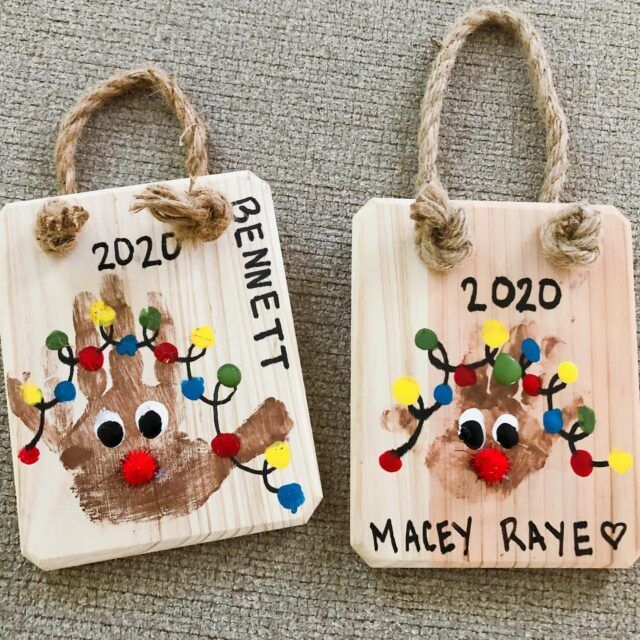 two handprinted wooden tags with reindeer faces on them, one is for the date