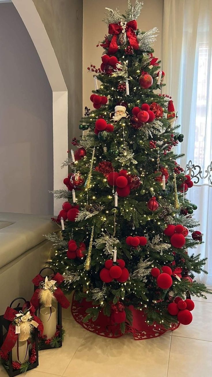 a christmas tree decorated with red and silver ornaments