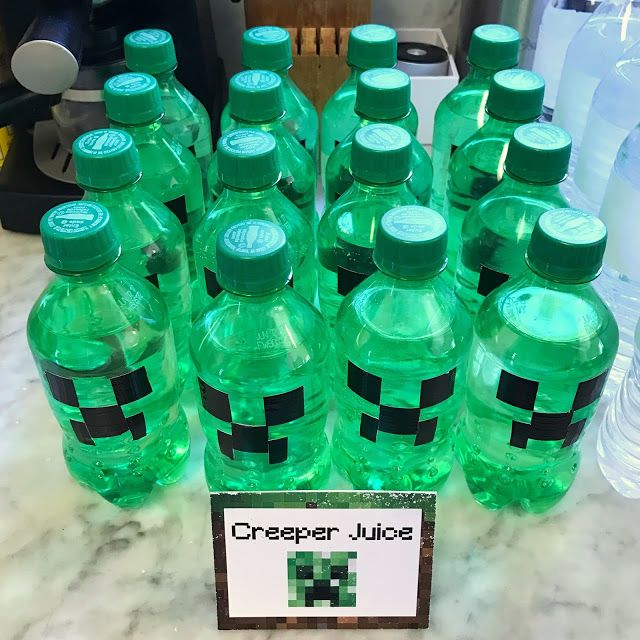 a bunch of green water bottles sitting on top of a counter