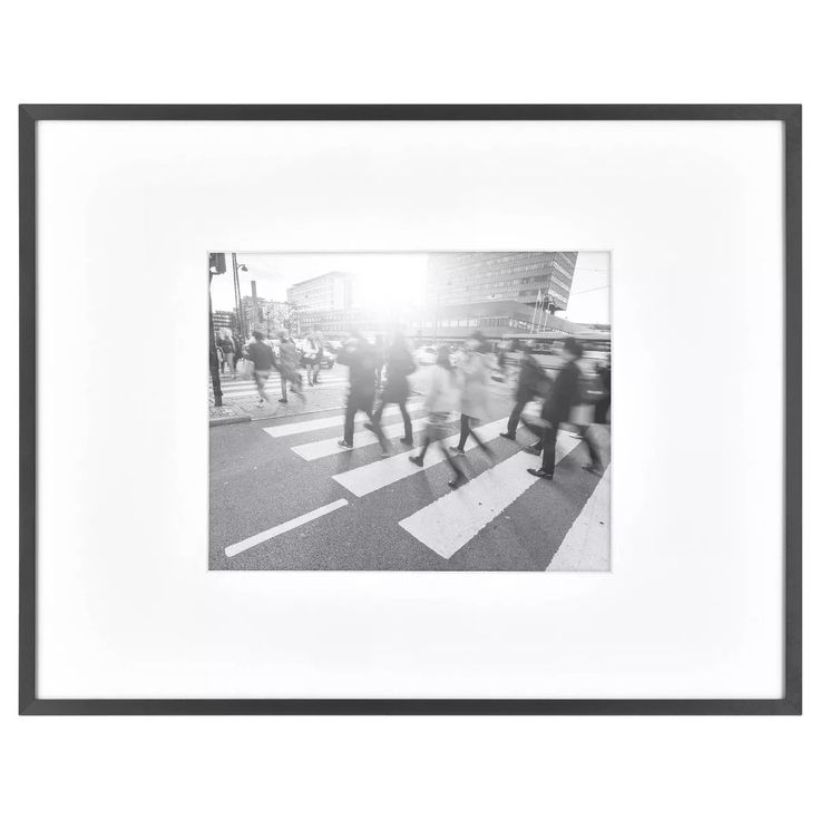 black and white photograph of people crossing the street