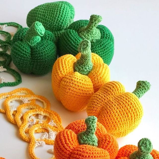 crocheted pumpkins and gourds on a white surface