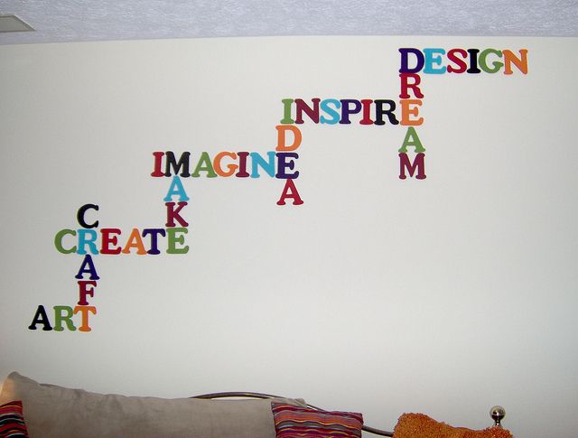 the wall is decorated with colorful letters on it