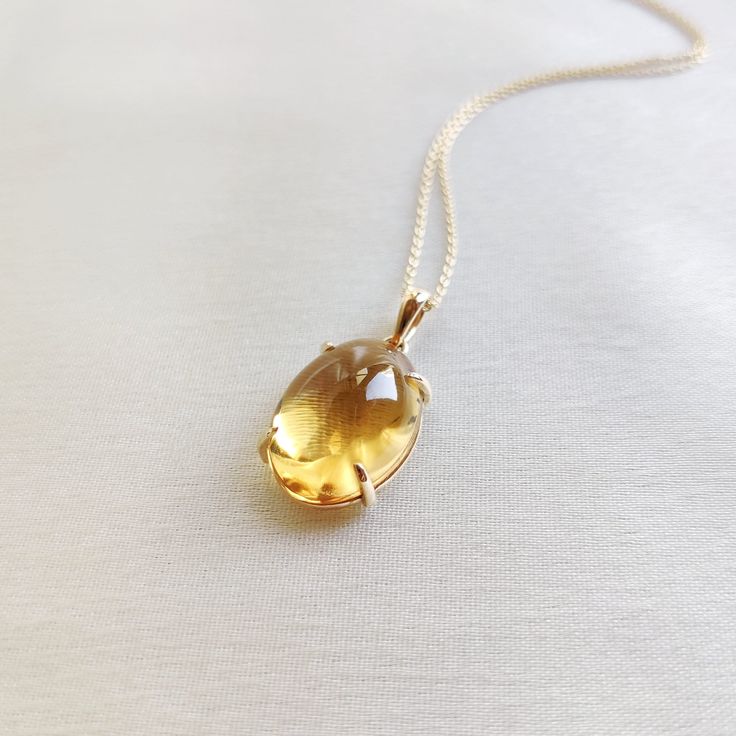 This stunning pendant is set in 14k Solid Yellow Gold with Natural Citrine with utmost precision. It is a unique gemstone pendant for nearly every occasion and is completely hassle-free jewelry. ITEM DETAILS: * GEM: Citrine * GEM Size: 13X18mm * GEM Shape: Oval * Gem Weight: 11.26 carats * Gold Purity: 14KT  * Gold Weight: 0.93 gram * Total Weight of the Pendant: 3.18 gram The Gold purity is guaranteed and it comes with an authentic 14KT gold hallmark. Since my items are handmade, they are absol Citrine Gemstone Oval Pendant Jewelry, Elegant Citrine Oval Pendant Jewelry, Elegant Oval Citrine Pendant Jewelry, Elegant Oval Amber Gemstones, Oval Citrine Gemstones For Gift, Oval Citrine Gemstone Necklaces, Yellow Gold Citrine Oval Pendant Jewelry, Elegant Oval Citrine Necklaces, Oval Citrine Necklace For Formal Occasions