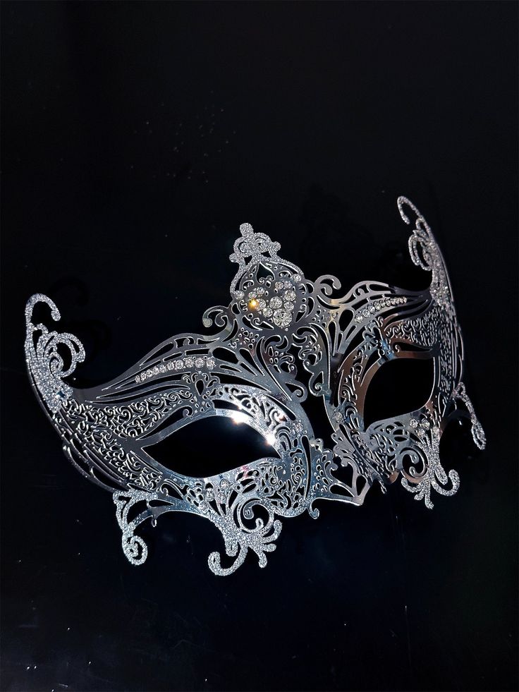 Step into the world of upscale glamour with our exquisite women's silver metal masquerade mask. The mask's silver shimmer adds an air of elegance, reflecting the light and adding a touch of enchantment to your appearance.

Age Group/Gender - Adult/Unisex

Size/Type - One size fits all adults

Mask Color - Silver

Shimmer Color - Silver

Mask Material - Lasercut Metal

Special Features - Rhinestones Silver Masquerade Mask, Masquerade Mask Women, Rhinestone Mask, Silver Mask, Metal Mask, Laser Cut Metal, Masks Masquerade, Masquerade Party, Ombre Effect