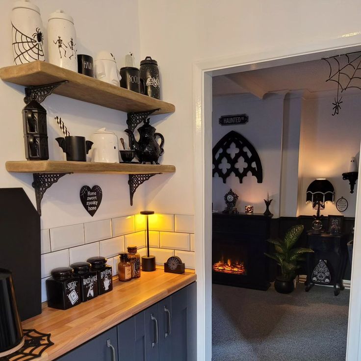 the kitchen is decorated with black and white decorations, such as coffee mugs on shelves