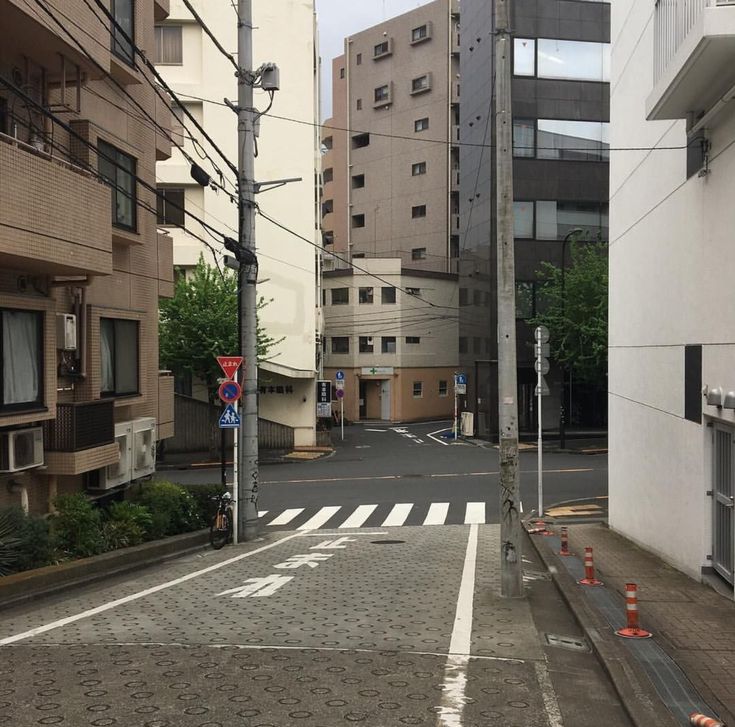 an empty city street with buildings in the background