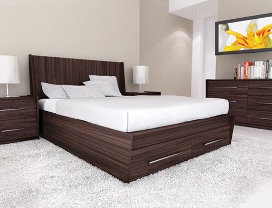 a large bed sitting on top of a white carpeted floor next to a night stand