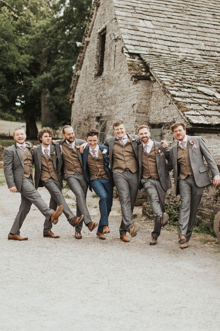 Groom in a blue suit takes a funny walking shot with the groomsmen in grey suits Grey And Brown Wedding, Tweed Groomsmen Attire, Brown And Blue Groomsmen Attire, Rustic Groom Suit, Groomsmen Tweed Suits, Groomsmen Attire Tweed, Blue And Brown Groomsmen, Barn Wedding Groomsmen Attire, Wedding Suits Groom Tweed