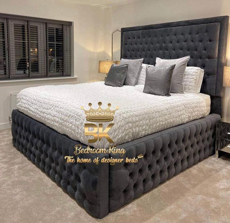 a large bed sitting in the middle of a bedroom