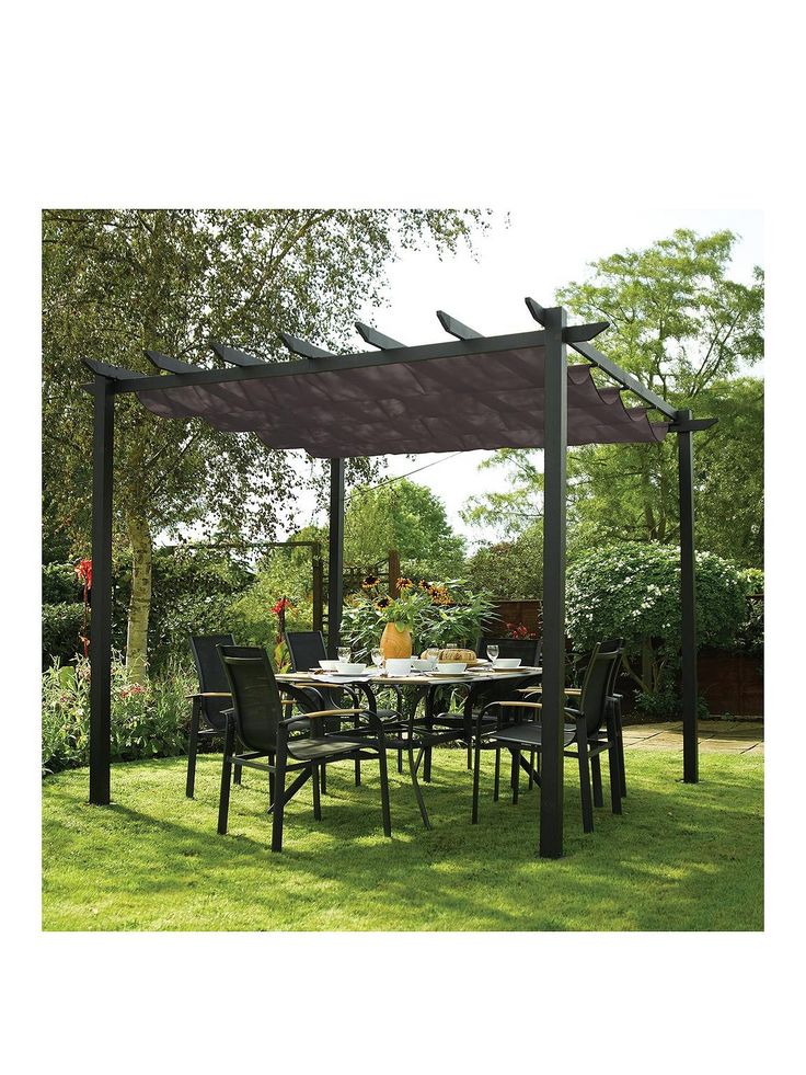 an outdoor dining area with table, chairs and pergolated roof in the grass