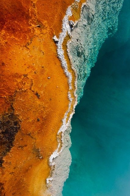 an aerial view of the water and land in this photo, looking down at it