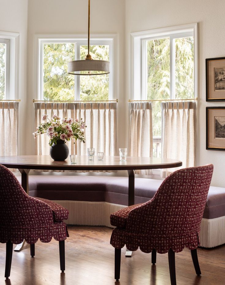 a dining room table with two chairs and a bench