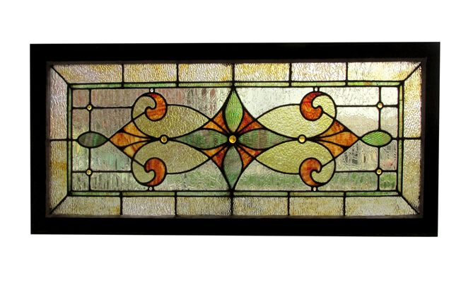 a stained glass window with an orange and green design on the bottom half of it