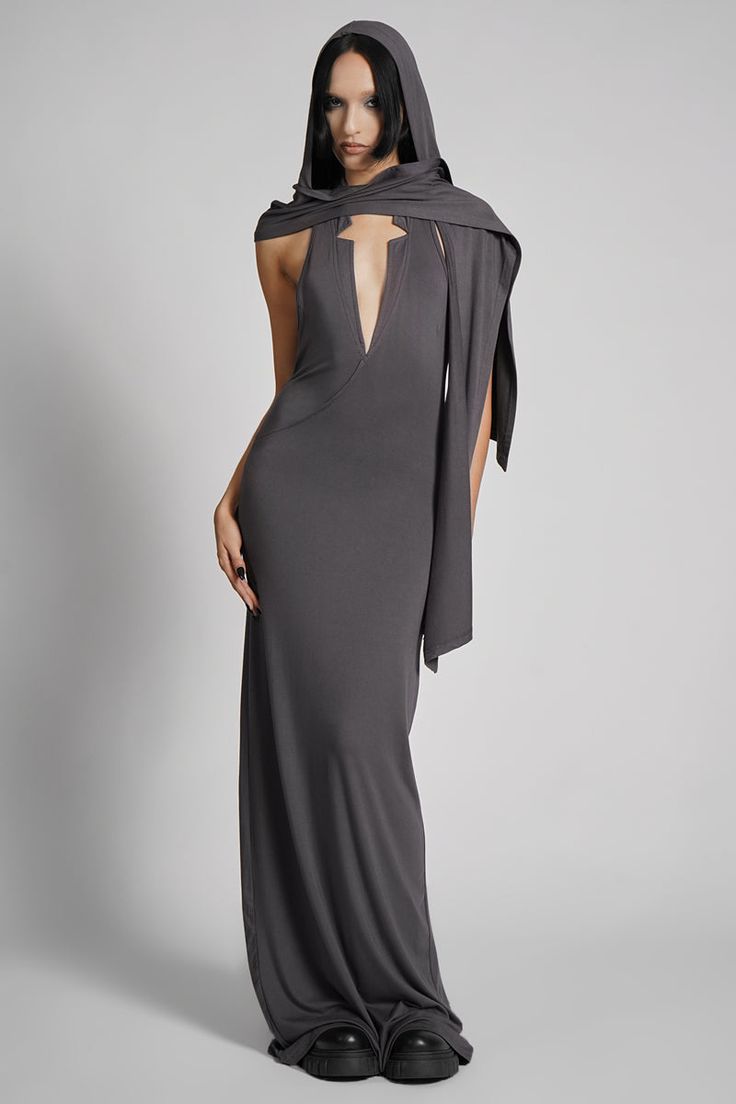 Make them take a second glance. Maxi dress made from luxuriously dense Jersey, featuring an add-on hood that can be draped across the shoulders and over the crown of the head, with plunging halter top neckline. FIT NOTES:Tatianna wears a size Small, 5'9, with a 26" waist.MATERIALS:95% rayon 5% spandexMade in China Senior Prom Ideas, Glamour Spell, Dress With Hood, Dystopian Fashion, Hood Pattern, Top Neckline, London Style, Senior Prom, Steel Grey