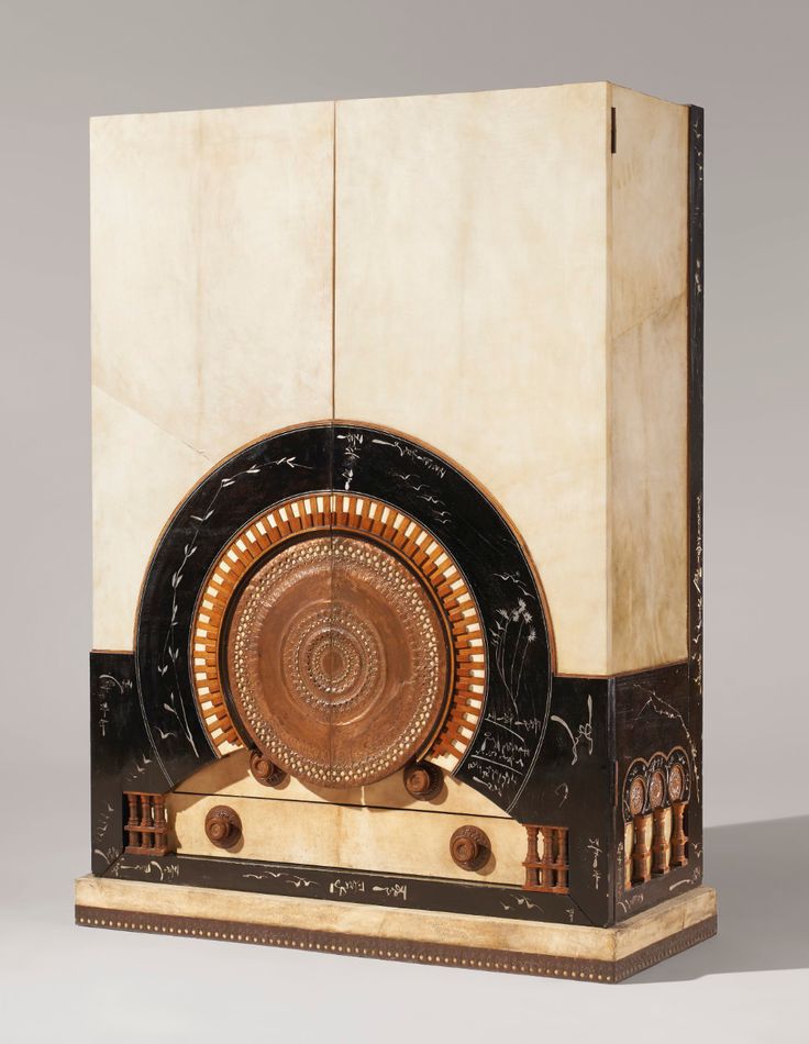 an art deco sculpture in the shape of a clock