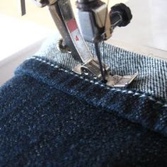 the sewing machine is working on the jeans