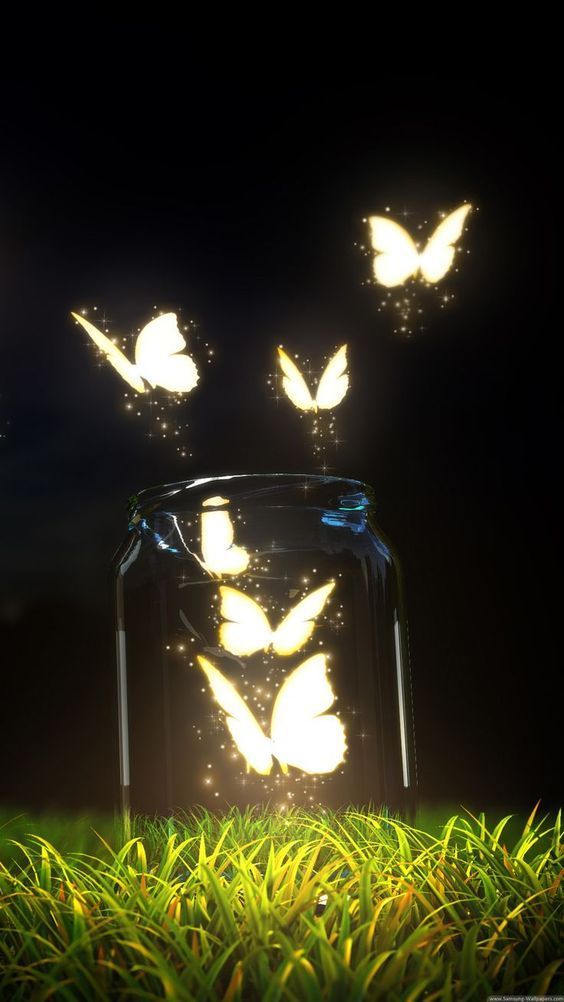 some butterflies are flying out of a glass jar on the grass in front of a black background