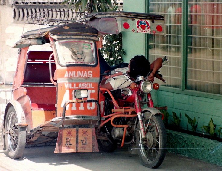 an orange and white truck parked next to a motorcycle