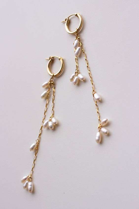 Completely handcrafted in our New York studio, the Falling Petals Mini Hoop Earrings feature genuine freshwater pearls. Lightweight and easy to wear. Wear them two ways - slide the dangle off to wear just the simple hoop earring. Ear wires: hoop Materials: 14k Gold Filled or Sterling Silver Measures approx. 3 3/4" (longest strand) in length Handmade in New York Arrives in a keepsake clutch and box Gold Earrings With Pearls, Easy To Make Earrings, Simple Earrings Design, Handmade Earrings Ideas, Pearl And Gold Earrings, Handmade Jewelry Ideas, Handmade Pearl Earrings, Gold Long Earrings, Simple Gold Jewelry