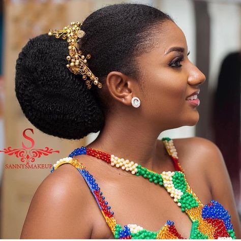 a woman in a colorful dress with beads on her head