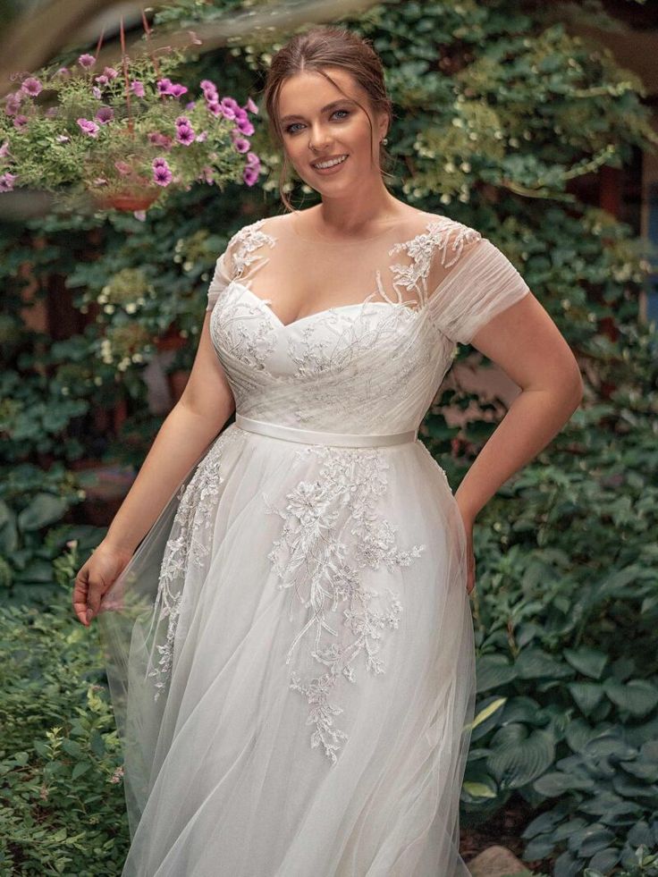 a woman in a wedding dress posing for the camera