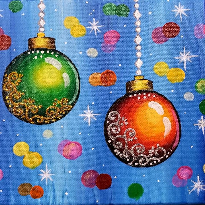 two christmas ornaments hanging from strings in front of a blue background with multicolored circles