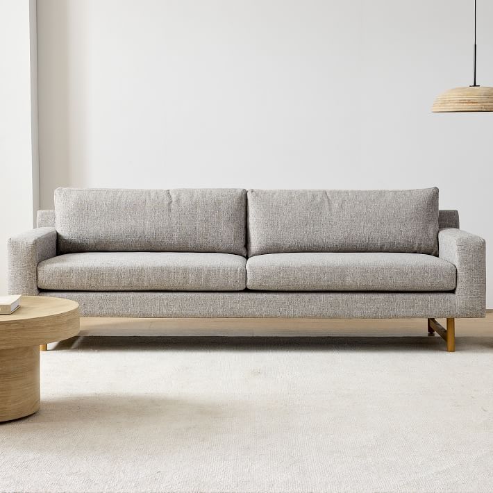 a living room scene with focus on the couch and coffee table in the foreground