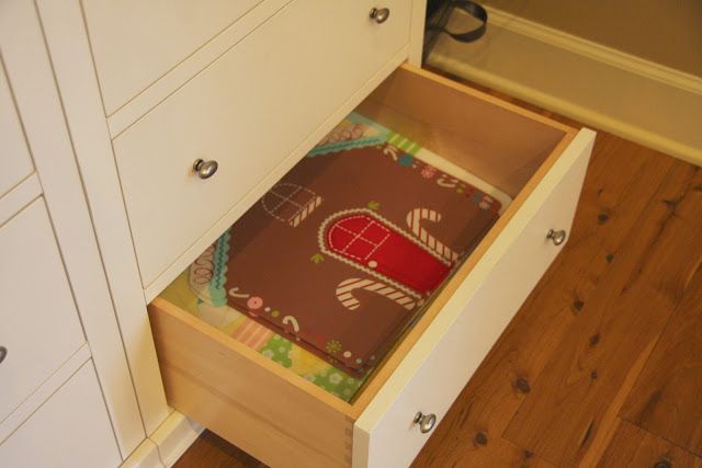 an open drawer on the floor in a kitchen