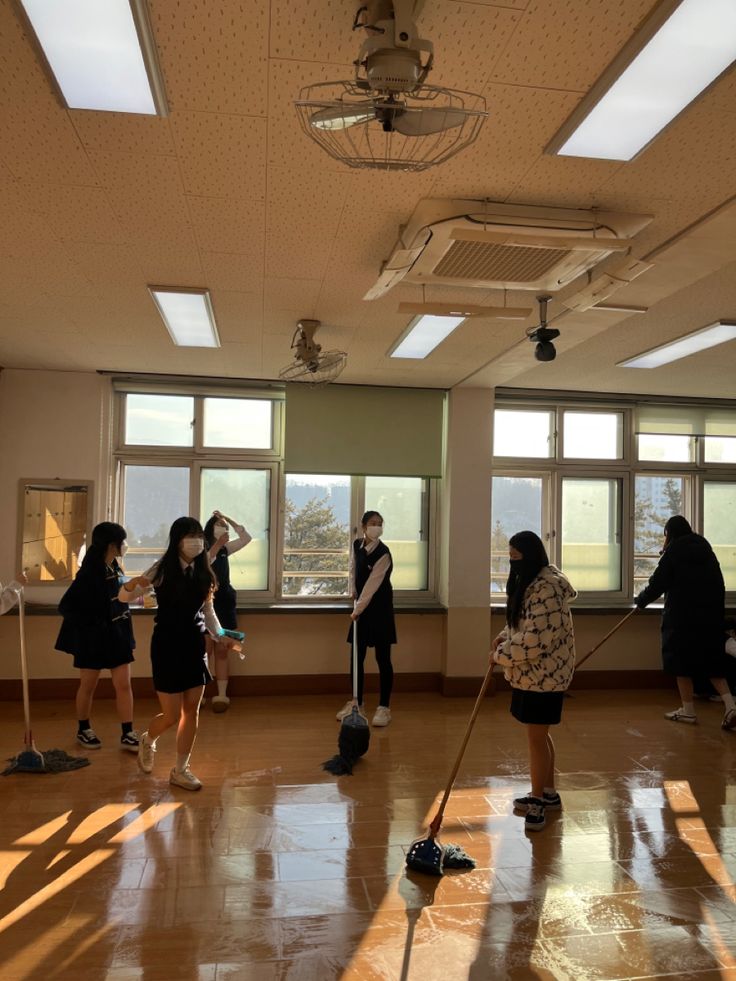 several people in a room with mop's and windows