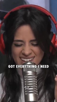 a woman wearing headphones and holding a microphone with the words, got everything i need