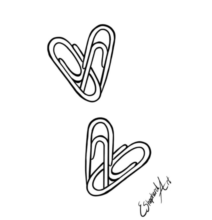 two paper clips in the shape of letters v and v on a white background with writing underneath